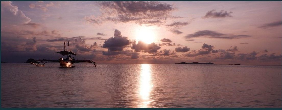 A bangka at sunset on a calm sea off Calaguas